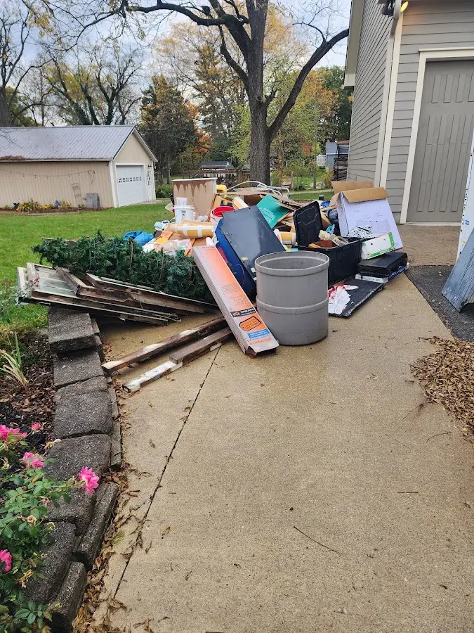 Dumpster being loaded with debris for Estate Cleanout Dumpster Rental in Lemont